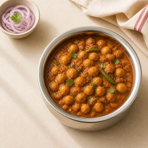 Chana masala — spiced chickpea curry, photographed from above in a steel bowl