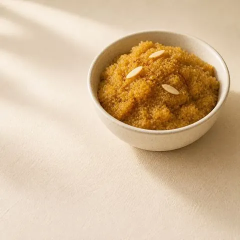 Moong dal halwa — slow-roasted yellow lentil halwa, photographed from above in a steel bowl