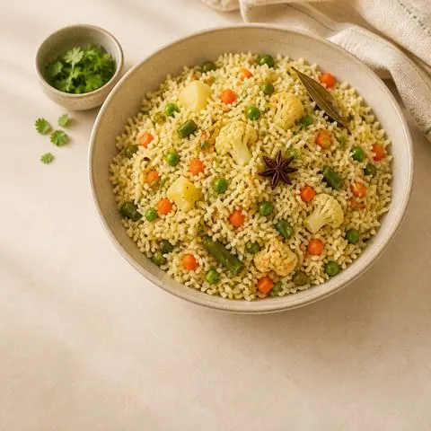 Vegetable pulao — vegetable pilaf, photographed from above in a steel bowl